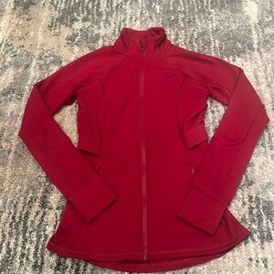 Red long sleeve full zip jacket 
Two front pockets 
One back pocket